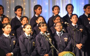 Students of St. Joseph's Convent Girls High School and St. Joseph's Convent PU College singing the invocation song to begin the commemoration event