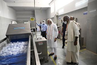 Shri Madhu Pandit Dasa showing around the kitchen equipment