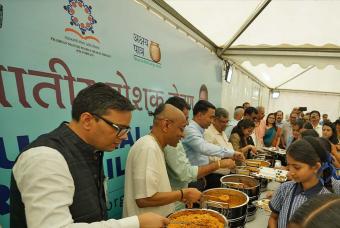 The dignitaries serve hot meals to schoolchildren at the inauguration ceremony.