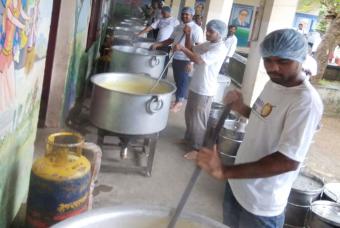 Taking turns to stir the dal