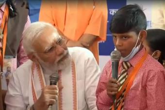 PM listens keenly to a beneficiary singing