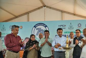 The ceremonious lighting of the lamp by the chief guest and other dignitaries.