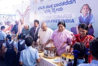 The guests lend a hand at serving smiles and mid-day meals to the beneficiaries.