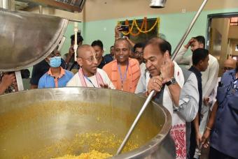 Trying a hand in the making of the nutritious meals that will be served at the event to children.