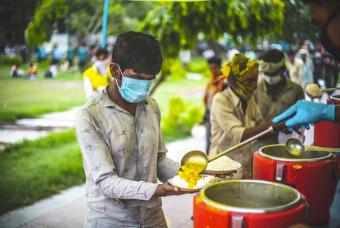 Hot food is served to the migrants.