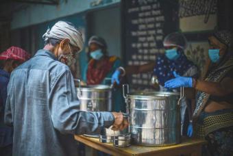 To sustain the pandemic 2.0, an elderly stocks food for later part of the day.