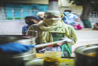 A woman waits in line for her turn.